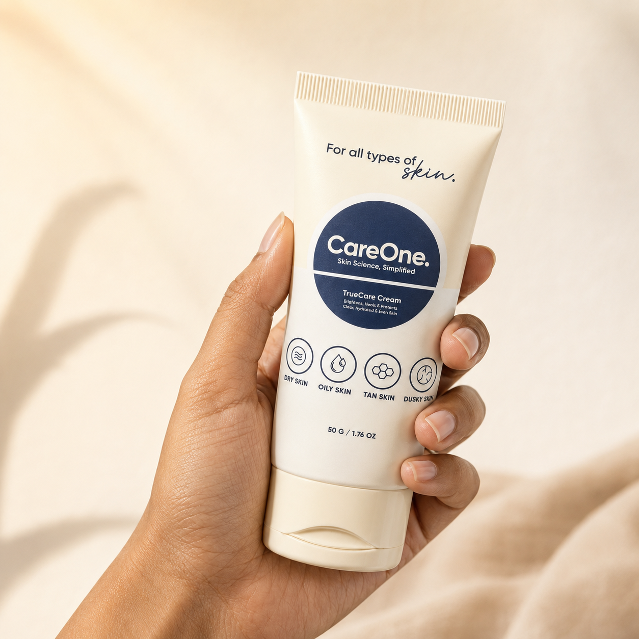 CareOne TrueCare Cream — held by hand against soft cream backdrop